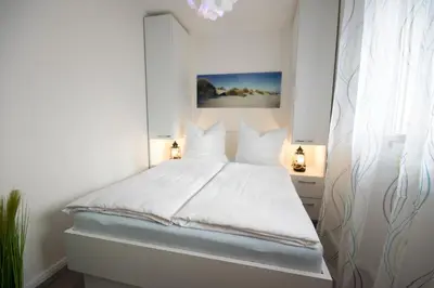 Ein Bett oder Betten in einem Zimmer der Unterkunft Am Sahlenburger Strand 04