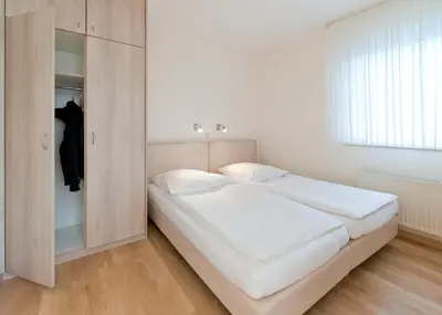 Ein Bett oder Betten in einem Zimmer der Unterkunft Haus Seemuschel - Fewo 2