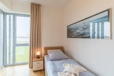 Ein Bett oder Betten in einem Zimmer der Unterkunft Residenz am Yachthafen Wohnung 5