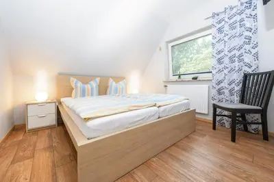 Ein Bett oder Betten in einem Zimmer der Unterkunft Ferienwohnung Kiebitz I