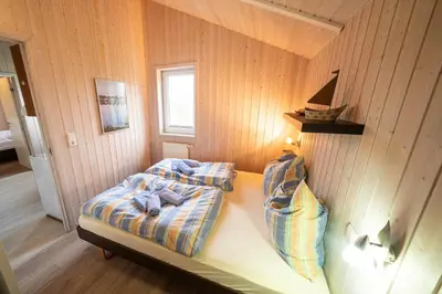 Ein Bett oder Betten in einem Zimmer der Unterkunft Ferienhaus Boldixum