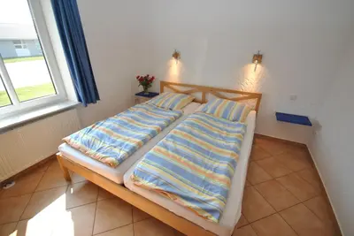 Ein Bett oder Betten in einem Zimmer der Unterkunft Ferienhaus Wattwurm