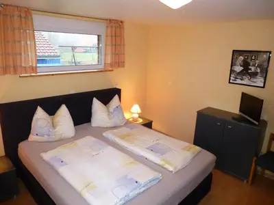 Ein Bett oder Betten in einem Zimmer der Unterkunft Ferienhaus Nordsee-Schwan