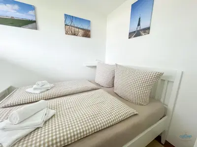 Ein Bett oder Betten in einem Zimmer der Unterkunft Haus Essen Whg. 22