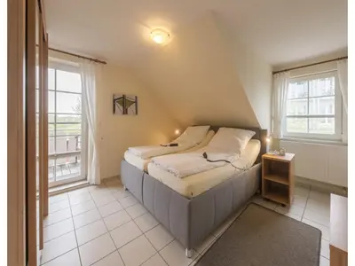 Ein Bett oder Betten in einem Zimmer der Unterkunft Ferienwohnung im OG in Friedrichkoog-Spitze