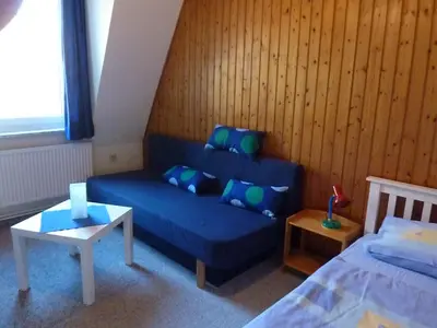 Ein Bett oder Betten in einem Zimmer der Unterkunft Ehemaliges Waldkurhaus Drangstedt
