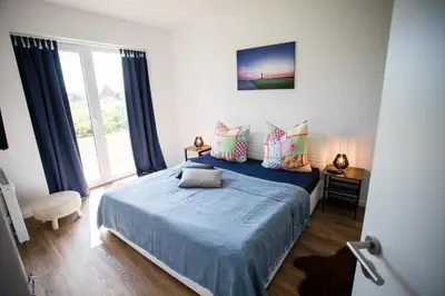 Ein Bett oder Betten in einem Zimmer der Unterkunft Strandchalet Elmo II