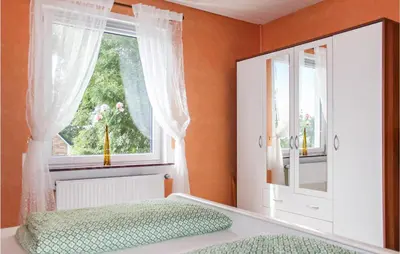 Ein Bett oder Betten in einem Zimmer der Unterkunft Cozy Apartment In Wurster Nordseeküste
