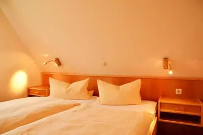 Ein Bett oder Betten in einem Zimmer der Unterkunft Landhaus Braband Ferienhaus - Rugenbargsweg 23