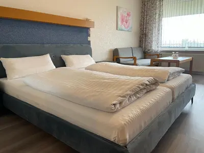 Ein Bett oder Betten in einem Zimmer der Unterkunft Seehotel Geestland