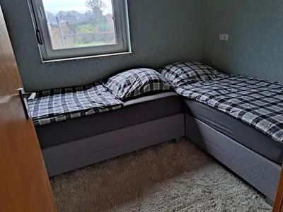 Ein Bett oder Betten in einem Zimmer der Unterkunft Ferienwohnung Lefering Stiftung