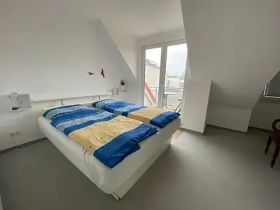 Ein Bett oder Betten in einem Zimmer der Unterkunft Duhner Brise, Ferienwohnung 5