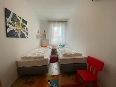 Ein Bett oder Betten in einem Zimmer der Unterkunft Duhner Brise, Ferienwohnung 2