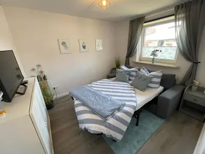 Ein Bett oder Betten in einem Zimmer der Unterkunft Ferienwohnung „Deichgeflüster“ nahe der Nordsee