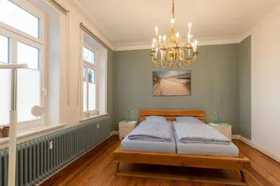 Ein Bett oder Betten in einem Zimmer der Unterkunft Haus Kapitäns Villa, Backkajüte