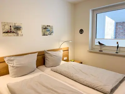 Ein Bett oder Betten in einem Zimmer der Unterkunft Haus Strandläufer Apartment 1 5
