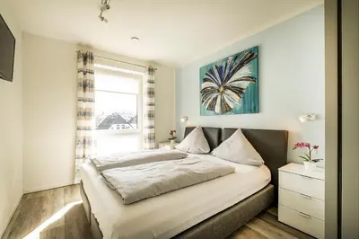 Ein Bett oder Betten in einem Zimmer der Unterkunft Haus Strandläufer Apartment 2 6 Strandperle