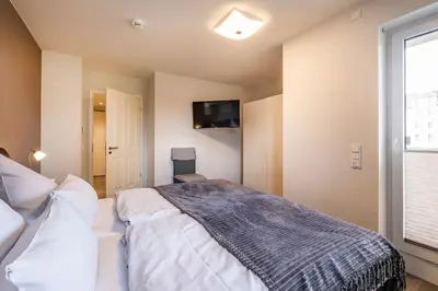 Ein Bett oder Betten in einem Zimmer der Unterkunft Haus Strandläufer Apartment 1 7 Strand-Idylle