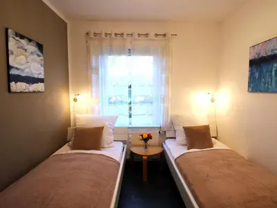 Ein Bett oder Betten in einem Zimmer der Unterkunft Residenz Helmsand