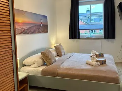 Ein Bett oder Betten in einem Zimmer der Unterkunft Residenz Vogelsand 2