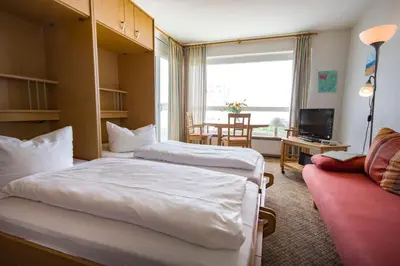 Ein Bett oder Betten in einem Zimmer der Unterkunft Frische Brise FeWo 10.08