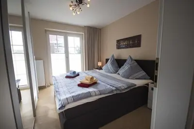 Ein Bett oder Betten in einem Zimmer der Unterkunft Residenz Steinmarne Cuxhaven 1