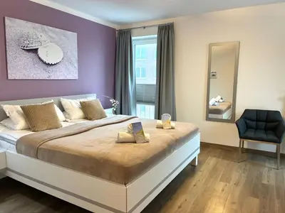 Ein Bett oder Betten in einem Zimmer der Unterkunft HP Touristik - Residenz Hohe Lith 40