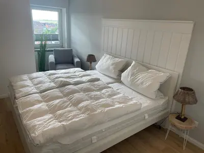 Ein Bett oder Betten in einem Zimmer der Unterkunft Deichliebe