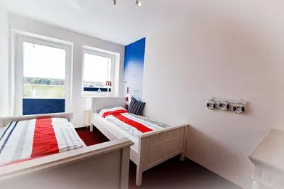 Ein Bett oder Betten in einem Zimmer der Unterkunft Haus Nordseebrandung NB45