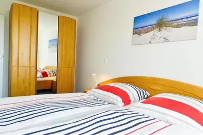 Ein Bett oder Betten in einem Zimmer der Unterkunft Haus Nordseebrandung NB51