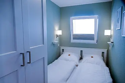 Ein Bett oder Betten in einem Zimmer der Unterkunft Strandhochhaus SHC2