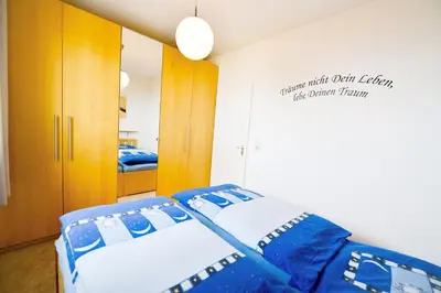 Ein Bett oder Betten in einem Zimmer der Unterkunft Strandhochhaus SF14