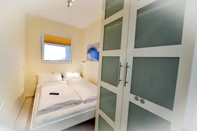 Ein Bett oder Betten in einem Zimmer der Unterkunft Strandhochhaus SG03
