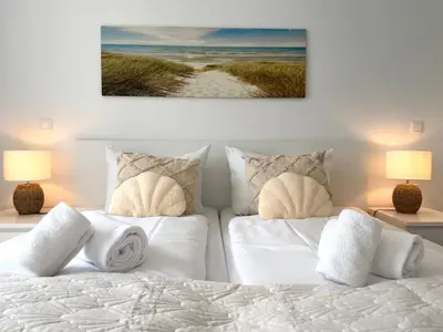 Ein Bett oder Betten in einem Zimmer der Unterkunft Nordseebrandung NB A1 1