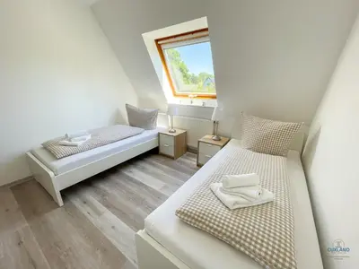 Ein Bett oder Betten in einem Zimmer der Unterkunft Residenz Grantz Sahlenburg Wohnung 1