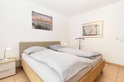 Ein Bett oder Betten in einem Zimmer der Unterkunft Nordseeblick 5