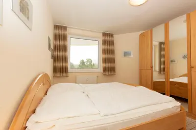 Ein Bett oder Betten in einem Zimmer der Unterkunft Kurpark-Residenz 209