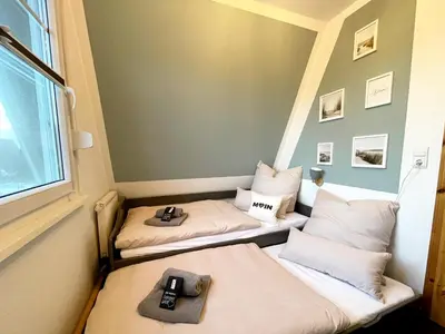 Ein Bett oder Betten in einem Zimmer der Unterkunft Familienfreundliches Ferienhaus in 5 min zum Strand mit Terrasse und kostenlosem Parkplatz
