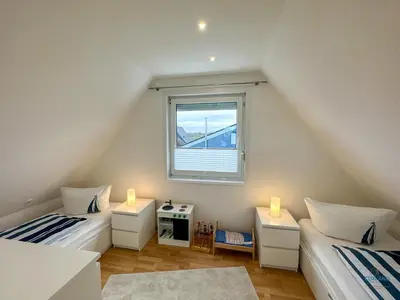 Ein Bett oder Betten in einem Zimmer der Unterkunft Ferienhaus Seepferdchen Duhnen