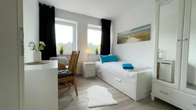 Ein Bett oder Betten in einem Zimmer der Unterkunft Nordseebrandung FeWo A4 3