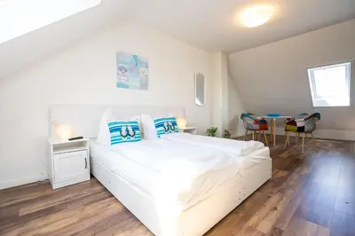 Ein Bett oder Betten in einem Zimmer der Unterkunft Residenz Rosengarten Wohnung Meerjungfrau 1
