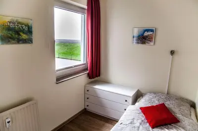 Ein Bett oder Betten in einem Zimmer der Unterkunft Dünenglück, Ferienwohnung 24