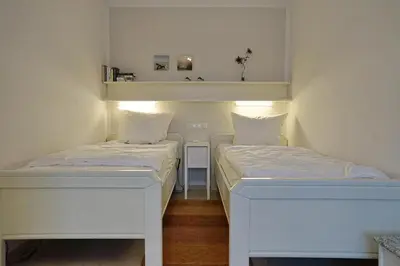 Ein Bett oder Betten in einem Zimmer der Unterkunft Viktoriastraße 5 Lünser 18 mit Strandkorb am Hauptstrand