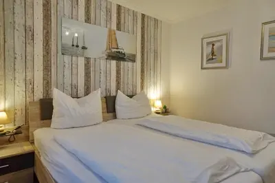 Ein Bett oder Betten in einem Zimmer der Unterkunft Seemeile 2 18 Seestern