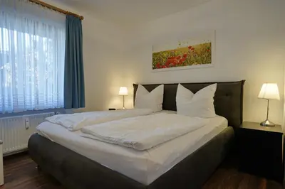 Ein Bett oder Betten in einem Zimmer der Unterkunft Schloss am Meer Wohnung 31
