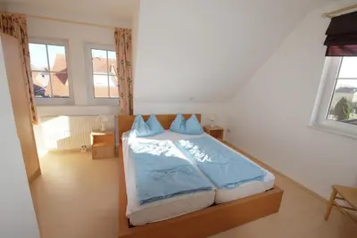 Ein Bett oder Betten in einem Zimmer der Unterkunft Haus Albatros