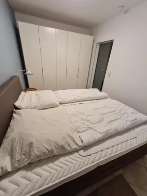 Ein Bett oder Betten in einem Zimmer der Unterkunft Nautilus, Ferienwohnung 5 inkl Strandkorb