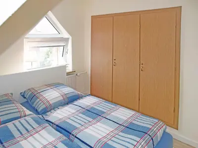 Ein Bett oder Betten in einem Zimmer der Unterkunft Haus Strandkrabbe, Seemöwe