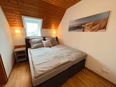 Ein Bett oder Betten in einem Zimmer der Unterkunft Frieda - Ferienwohnung mit Deichblick
